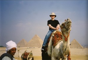 Author on camel-back at Giza with Great Pyramids in background