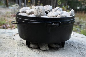 Dutch oven cooking on top of flat rock 