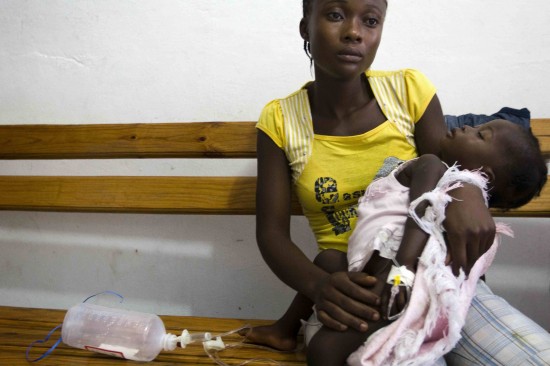 On 21 October, a woman holds her baby, who is suffering from acute diarrhoea, in St. Nicholas Hospital in Saint-Marc, a town in Artibonite Department. The illness is suspected to be cholera,
