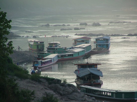 Laos Lunag Prabang longboats on the Mekong at dusk Picture by Vincent Ross