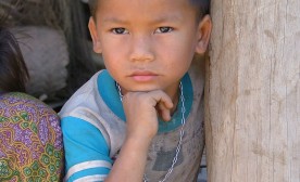 Laos: Mekong River A Lao Lue boy in the village of Khon Toune