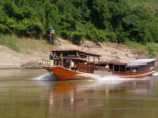 Laos, a longboat on the Mekong River Picture by Vincent Ross