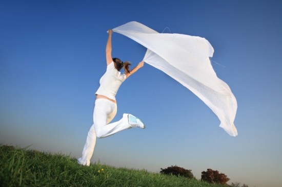 Woman running and jumping outdoors