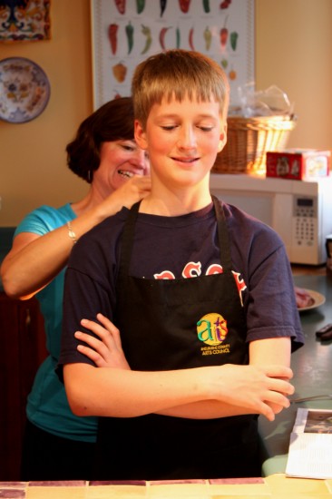 A mom helps prep her chef son for cooking
