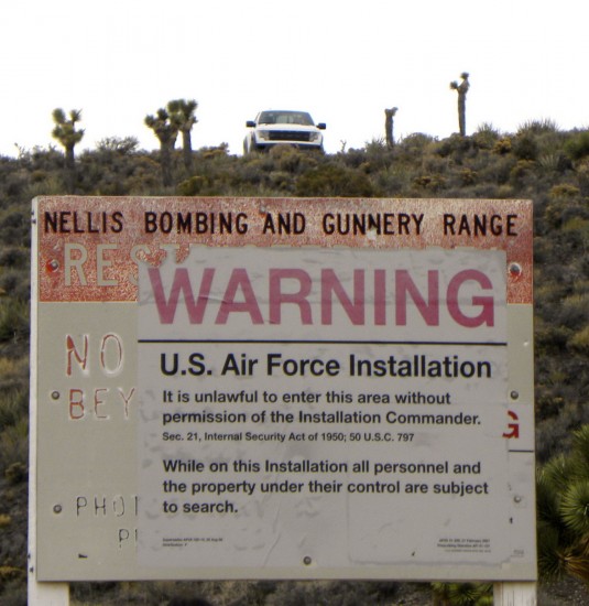 Ford SUV and occupants keeping an eye on uninvited visitors to Area 51 perimeter
