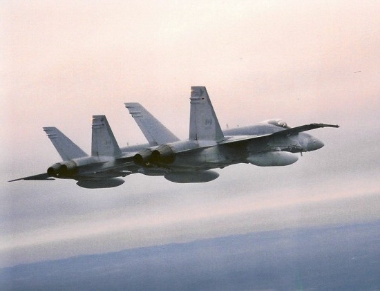 Two of 433 Squadron's CF-18's flying in tight formation over the skies near Bagotville