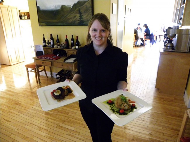 Our waitress Sheena holding our orders of house-made Strozzapreti and Cumin Crusted Cod.