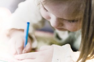 Little girl with a pencil