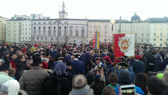 Completing the firing of the 4:00 p.m. cannon officially starting New Years Eve celebrations in Salzburg, with the Hohensalzburg Castle high on top of the hill in the background from where fireworks will ring in 2014.