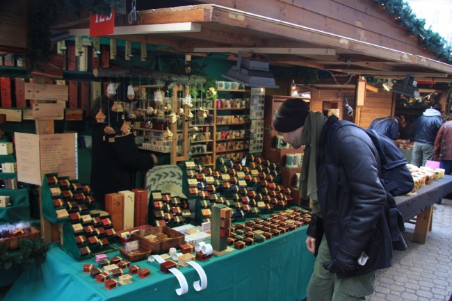 Jonathan picking out a miniature, wooden music box at the Deak Ferenc Street Christmas Market, Budapest.