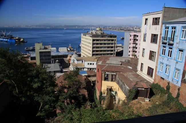 The Valparaiso apartment buildings in the foreground were built on the side of a hill, on bed rock, during the late 1800s to early 1900s. The two spires in the middle of the photograph are commercial buildings built during the same time as the apartment buildings and again on bedrock at the foot of the hill. They all remain intact. While the modern buildings in the background are built on landfill and the original commercial buildings collapsed during earthquakes. 