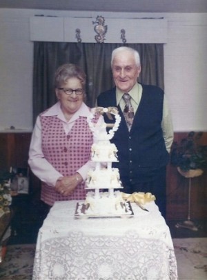Nan and Boo, Daisy and Billy Buss, on their 60th Wedding Anniversary in 1980 standing in their quaint living room, just ready for the party with many friends and family.