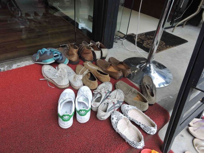 Shoes outside a massage parlour in Chiang Mai, Thailand