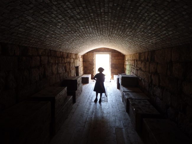 A young boy in period costume enters Fort Beausejour's spooky tunnels