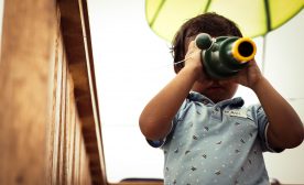 A child with a toy telescope